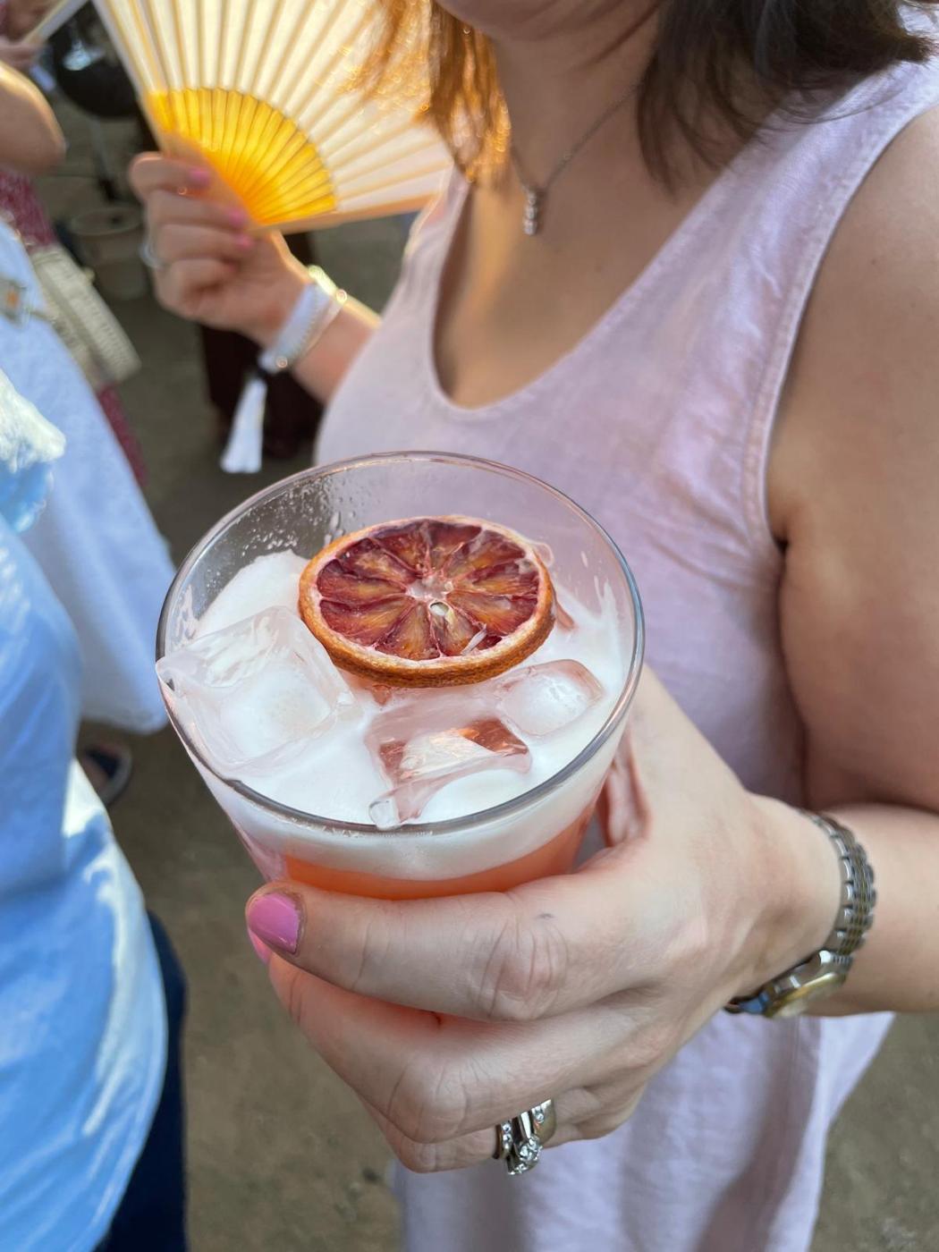 Blood orange cocktail with a dried orange wheel at a private party